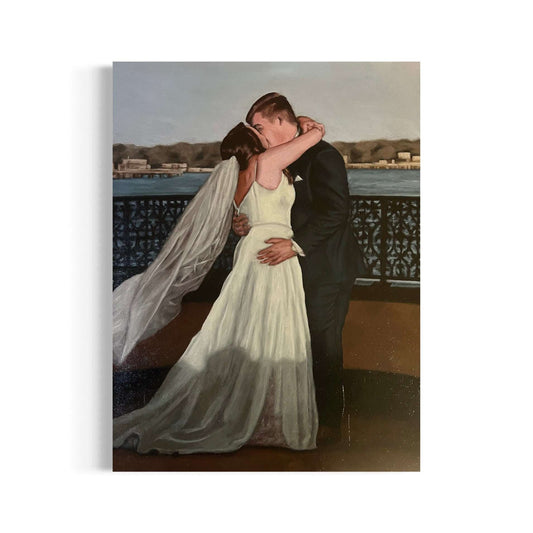 Bride and groom kissing in front of the river